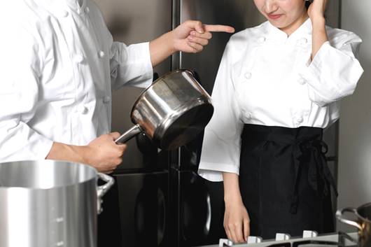 Chef pointing to female employee - FMLA Retaliation